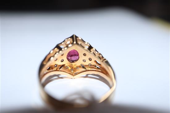 A modern pierced 14ct gold, ruby and diamond hexagonal cluster ring, size N/O.